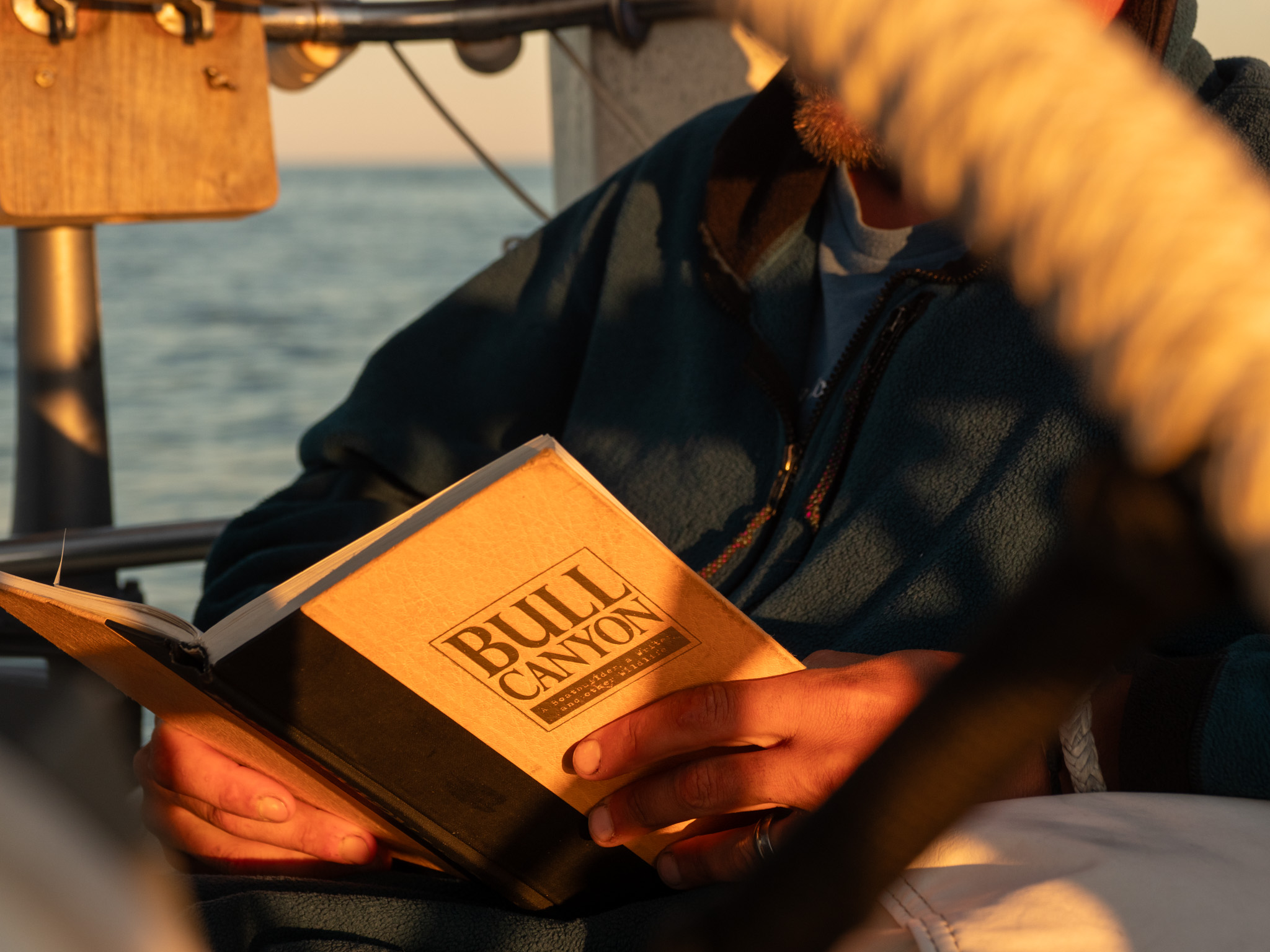 Chris reading a signed copy of Bull Canyon, sent to us from Lin Pardey herself for Chris's birthday.